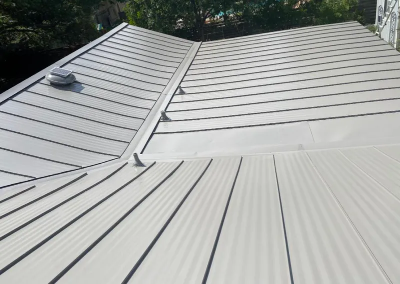 Solar attic fan installed on a metal roof for Roof Ventilation in Port Neches